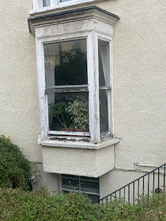 Damaged sash window requiring professional repair.